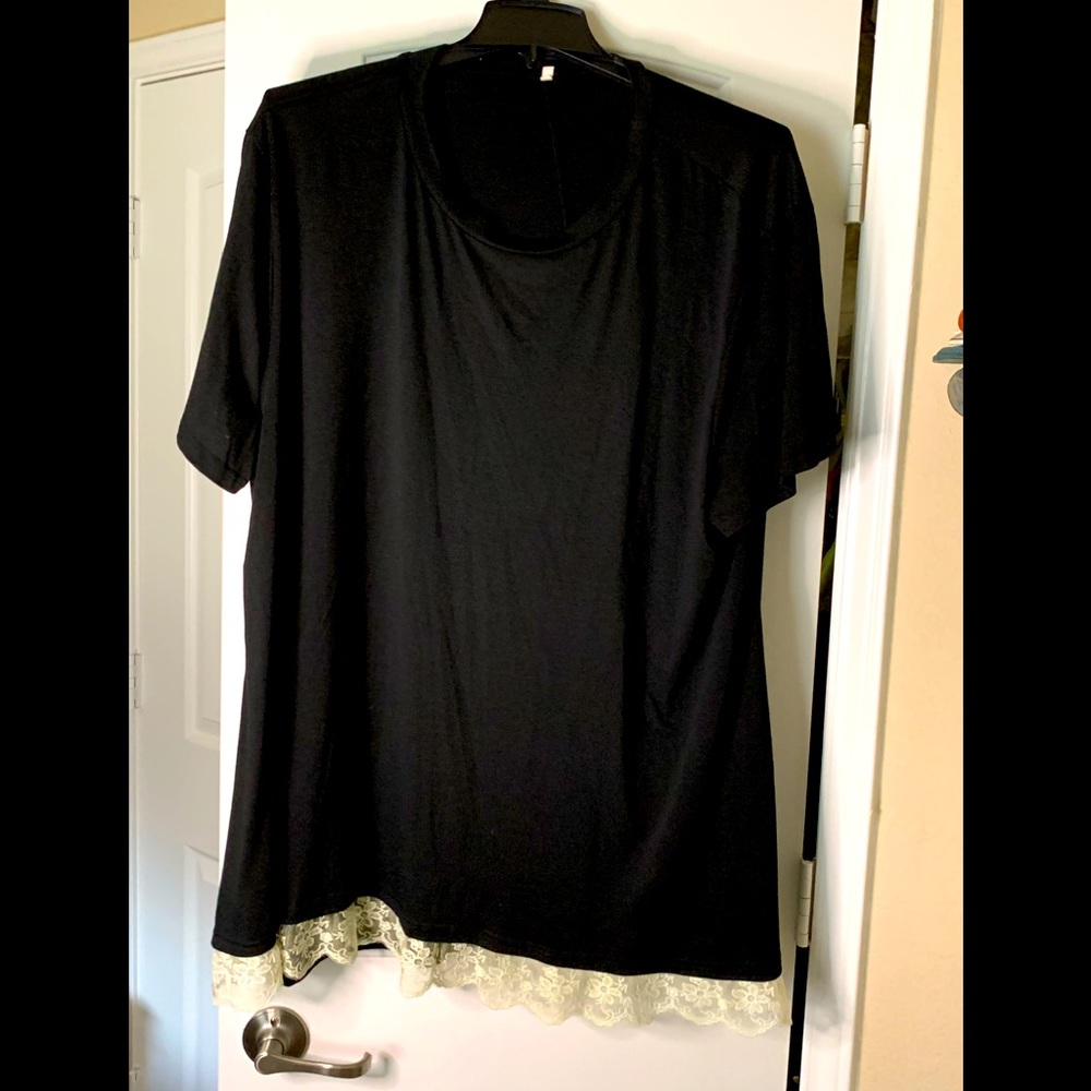 Black t-shirt with a cream color lace detail on bottom of the shirt. Size 26W.